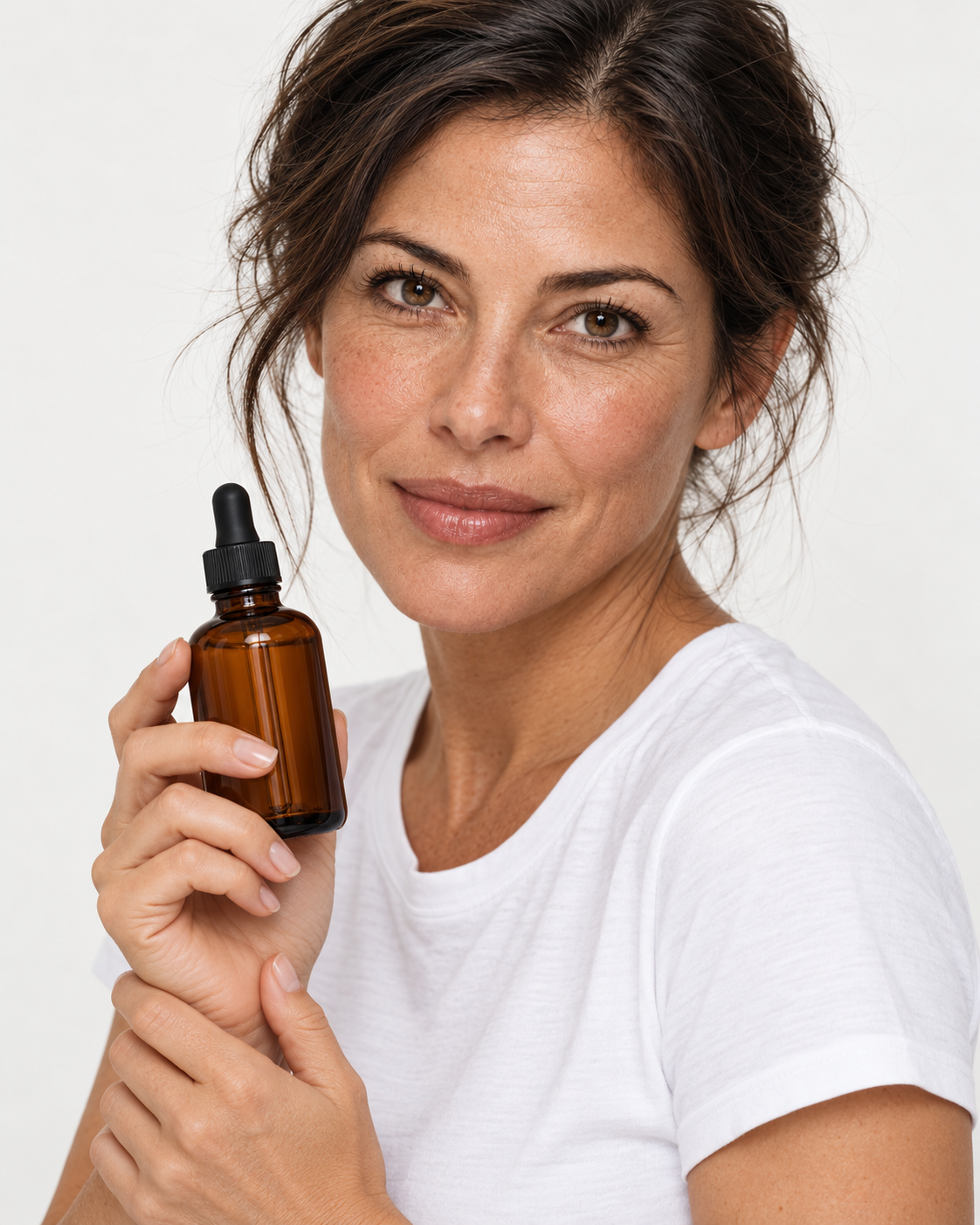 A woman in a white T-shirt holding Peunia Face Serum